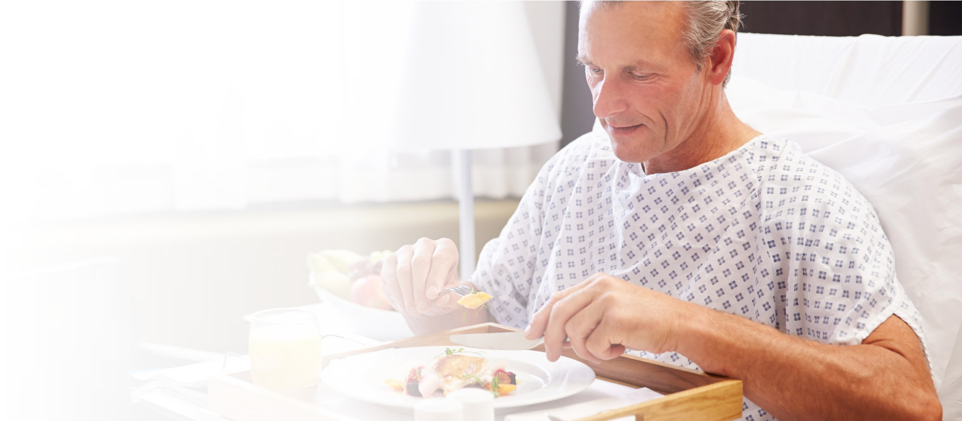 Man in hospital eating fresh food