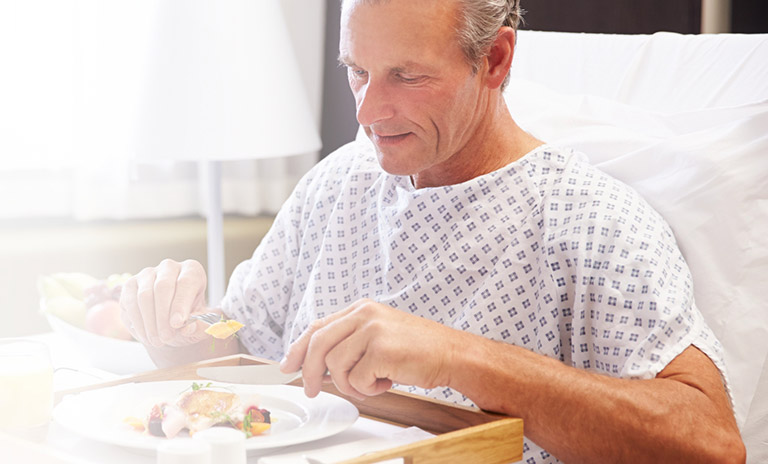 Man in hospital eating fresh food
